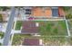 Aerial shot of fenced property, concrete patio, brown roof and light-blue exterior paint at 8505 N Brooks St, Tampa, FL 33604