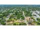 Expansive aerial view of a neighborhood with lush greenery, showcasing the property's location and surrounding community amenities at 8505 N Brooks St, Tampa, FL 33604