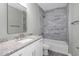 Bathroom featuring marble-style tile, granite countertop, and white vanity cabinets at 8505 N Brooks St, Tampa, FL 33604
