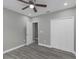 Bedroom with wood-look flooring, ceiling fan, closet, and neutral paint at 8505 N Brooks St, Tampa, FL 33604