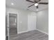 Bedroom features wood-look floors, ceiling fan, white trim, and closet at 8505 N Brooks St, Tampa, FL 33604