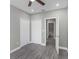 A bedroom with gray walls and flooring, showcasing a view into a bathroom and closet at 8505 N Brooks St, Tampa, FL 33604