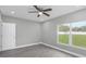 Bright bedroom with ceiling fan and outdoor views at 8505 N Brooks St, Tampa, FL 33604