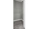 Empty closet with gray walls, white trim, gray flooring, and a wire shelf at 8505 N Brooks St, Tampa, FL 33604