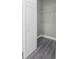 Empty closet with gray walls, white trim, gray flooring, and a wire shelf at 8505 N Brooks St, Tampa, FL 33604