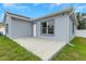 Backyard showing green grass, a white fence, and view of house from the back at 8505 N Brooks St, Tampa, FL 33604
