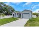 Beautiful new construction featuring a one car garage and landscaping at 8505 N Brooks St, Tampa, FL 33604