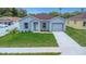 Well-maintained single-Gathering home featuring a one car garage and neat landscaping at 8505 N Brooks St, Tampa, FL 33604