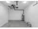 Clean garage featuring sealed concrete floors and utility access at 8505 N Brooks St, Tampa, FL 33604