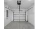 A clean and empty garage with an automatic door and concrete flooring at 8505 N Brooks St, Tampa, FL 33604