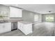 Kitchen with modern appliances, white cabinets, and gray countertop at 8505 N Brooks St, Tampa, FL 33604