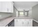 Kitchen island with granite countertop and view to the living room at 8505 N Brooks St, Tampa, FL 33604