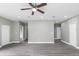 Open-concept living room with ceiling fan and multiple doors at 8505 N Brooks St, Tampa, FL 33604