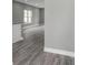 Open-concept living room with gray walls and wood-look vinyl floors at 8505 N Brooks St, Tampa, FL 33604