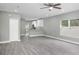 Bright and airy living room with gray wood-look floors and a view of the modern kitchen at 8505 N Brooks St, Tampa, FL 33604