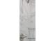 Luxurious shower with marble-patterned tile, glass door and built-in glass shelves at 8505 N Brooks St, Tampa, FL 33604