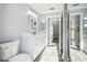 Well-lit bathroom with a walk-in shower, toilet, and modern vanity at 8818 Poe Dr, Hudson, FL 34667