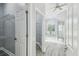 Bright bathroom with separate tub and shower and walk-in closet at 8818 Poe Dr, Hudson, FL 34667