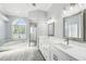 Bright bathroom with dual sinks, separate tub and shower, and modern fixtures at 8818 Poe Dr, Hudson, FL 34667