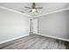 This is a bedroom with gray wood floor, gray walls and white trim at 8818 Poe Dr, Hudson, FL 34667