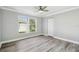 This is a bedroom with gray wood floor, gray walls and white trim at 8818 Poe Dr, Hudson, FL 34667