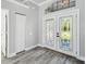 Bright entryway featuring wood flooring, decorative glass doors, and elegant trim at 8818 Poe Dr, Hudson, FL 34667