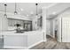 Open kitchen with island, gray cabinets, quartz counters, flowing to bath and bedrooms at 8818 Poe Dr, Hudson, FL 34667