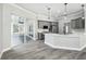 Kitchen with island, stainless steel appliances, and connection to outdoor living at 8818 Poe Dr, Hudson, FL 34667