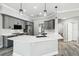 Spacious kitchen featuring a large island, gray cabinets, and quartz countertops at 8818 Poe Dr, Hudson, FL 34667