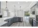 Kitchen boasts gray cabinets, quartz countertops, and backyard views at 8818 Poe Dr, Hudson, FL 34667