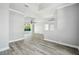 Spacious living room with wood-look floors, recessed lighting, and sliding glass doors to the pool at 8818 Poe Dr, Hudson, FL 34667