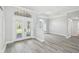 Open living area featuring wood floors, a large window, and glass doors leading to the outdoors at 8818 Poe Dr, Hudson, FL 34667