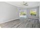 Bright living room featuring wood-look floors and sliding glass doors leading to outdoor pool area at 8818 Poe Dr, Hudson, FL 34667