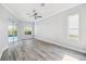Bright living room featuring wood-look floors and sliding glass doors leading to outdoor pool area at 8818 Poe Dr, Hudson, FL 34667