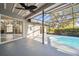 Outdoor screened pool area with large deck and mature landscaping at 8818 Poe Dr, Hudson, FL 34667