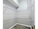 Bright walk-in closet equipped with wire shelving and modern flooring at 8818 Poe Dr, Hudson, FL 34667