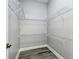 Walk-in closet equipped with wire shelving and modern flooring at 8818 Poe Dr, Hudson, FL 34667