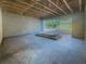 Unfinished basement space with concrete walls, a view to the sunny exterior, and potential for customization at 921 12Th N St, St Petersburg, FL 33705