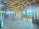 Spacious interior under construction with wooden frames, large windows, and natural light showcasing potential layout at 921 12Th N St, St Petersburg, FL 33705