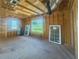 Under construction interior with natural light streaming through window frames and a view of lush greenery outside at 921 12Th N St, St Petersburg, FL 33705