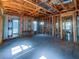 Large room is under construction, featuring exposed ceiling beams, open stud walls, and plenty of natural light at 921 12Th N St, St Petersburg, FL 33705
