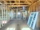 Room interior is under construction featuring wood framing, natural light from windows, and unfinished flooring at 921 12Th N St, St Petersburg, FL 33705