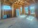Room under construction featuring wood framing, natural light from multiple windows, and unfinished flooring at 921 12Th N St, St Petersburg, FL 33705