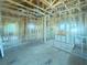Large room under construction featuring exposed ceiling beams, wood framing, and plenty of natural light at 921 12Th N St, St Petersburg, FL 33705