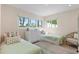 Bright bedroom with two twin beds, neutral colors, and plenty of natural light from the windows at 1112 38Th Ne Ave, St Petersburg, FL 33704