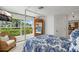 Comfortable bedroom with a four-poster bed, accent chair, and large windows offering outdoor views at 1112 38Th Ne Ave, St Petersburg, FL 33704
