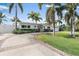 Beautiful home featuring a circular driveway, mature trees, and manicured landscaping at 1112 38Th Ne Ave, St Petersburg, FL 33704