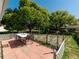 Paver patio with white lattice, table, and chairs, perfect for outdoor dining at 12202 Meadowbrook Ln, Hudson, FL 34667