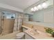 Well-maintained bathroom with a shower/tub combo and a large mirror at 12202 Meadowbrook Ln, Hudson, FL 34667