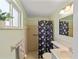Bathroom featuring a walk-in shower with a floral shower curtain and a window at 12202 Meadowbrook Ln, Hudson, FL 34667